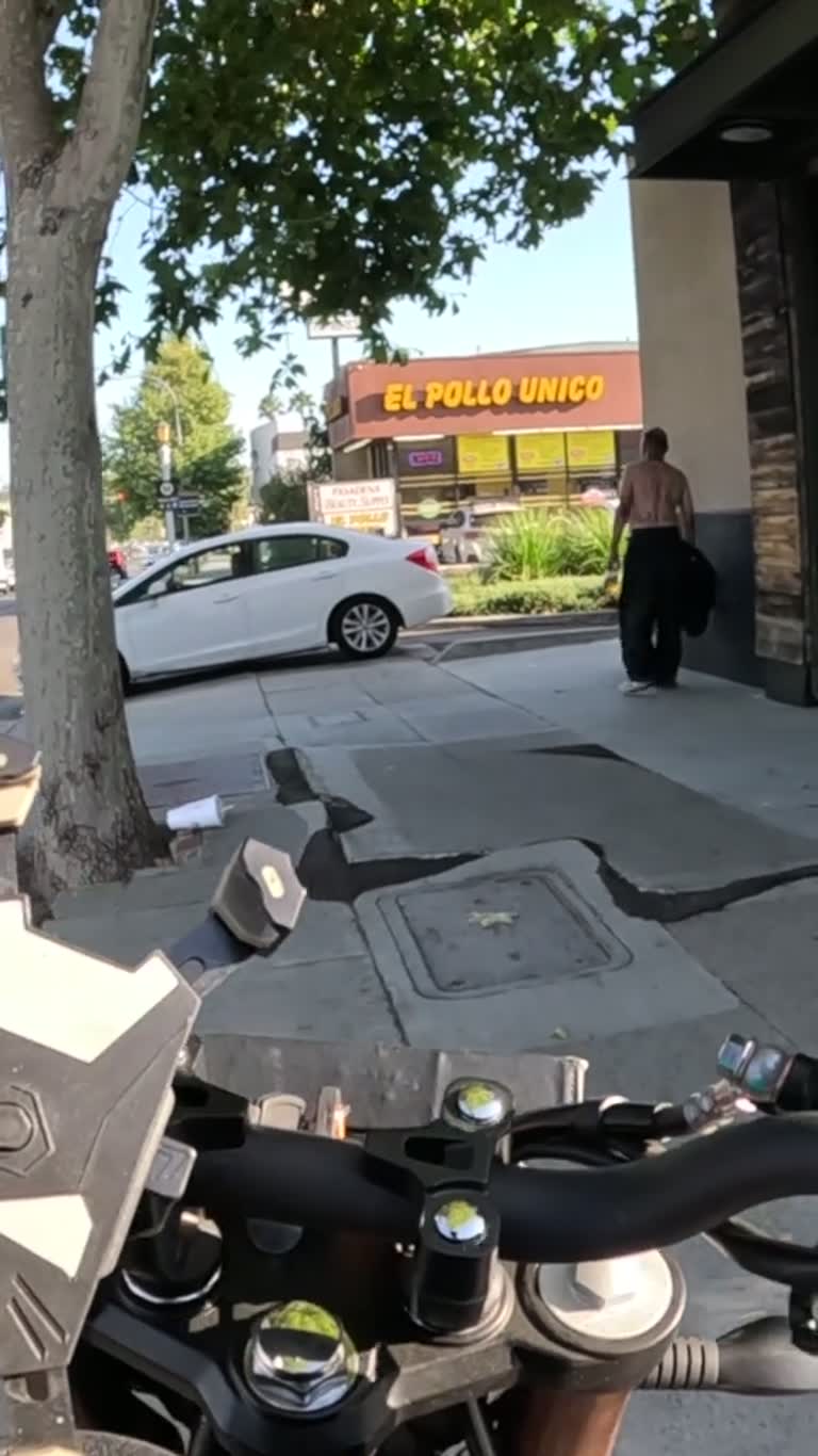 Motorcyclist Offers Food to a Man Who Says He Is Very Angry