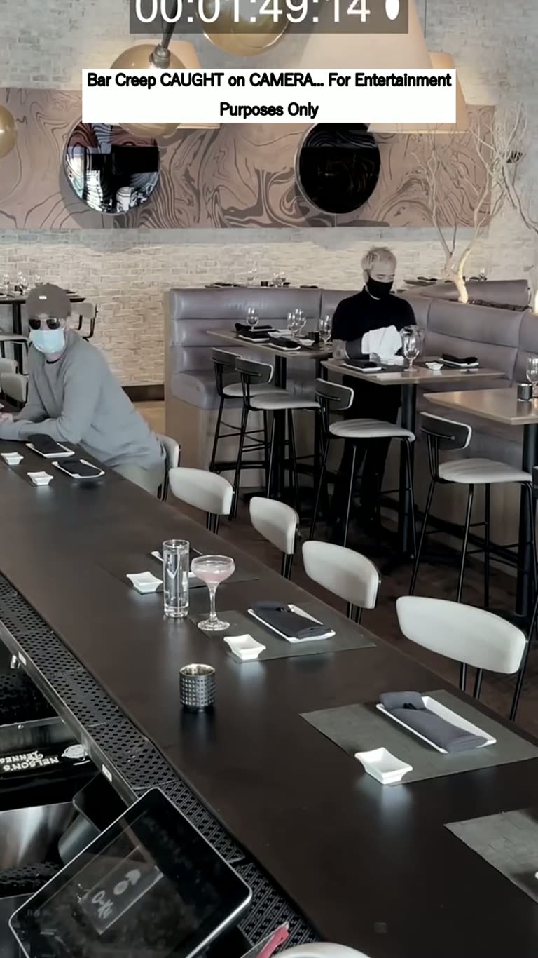 A Timestamped Bar Clip, a Pink Drink and a Man Who Keeps Watching