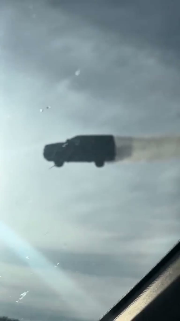 An SUV Hangs in the Clouds in a Clip Drivers Call a Glitch