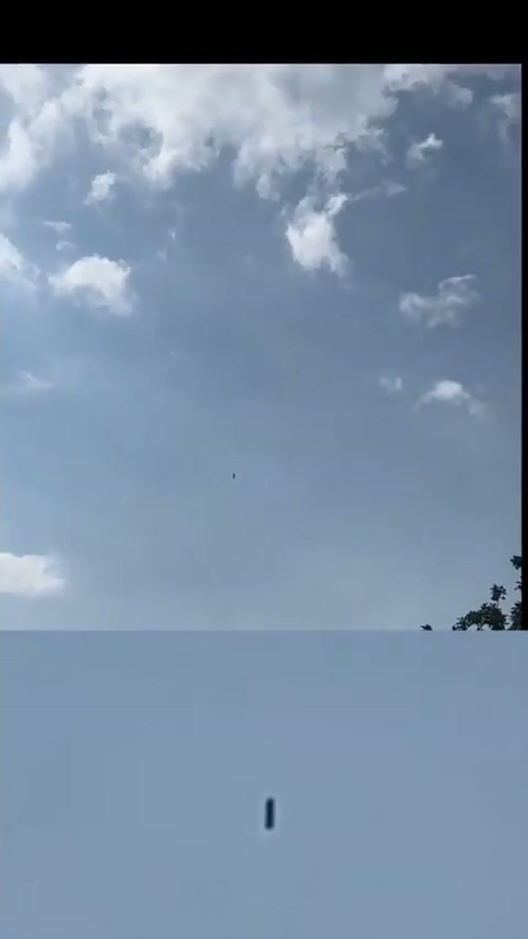 Dark Cylindrical Object Hovers Over Swiss Pasture in Viral Clip