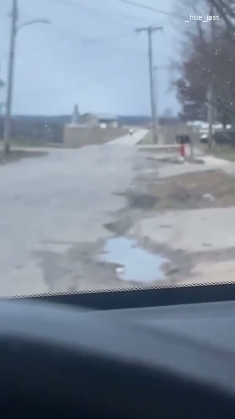 Jogger Appears Frozen in Place on Quiet Road in Odd Clip