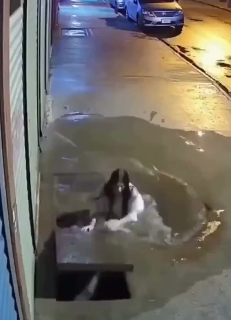 Woman Falls Through a Sidewalk Gap on a Rainy Night Walk