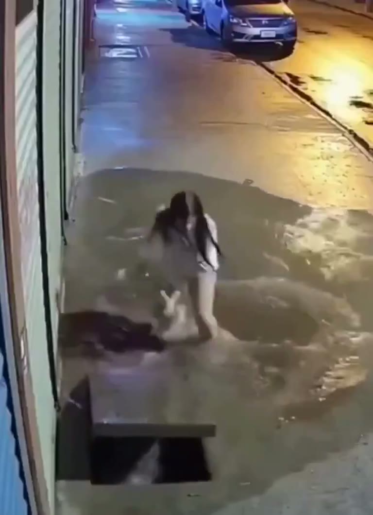 Woman Falls Through a Sidewalk Gap on a Rainy Night Walk