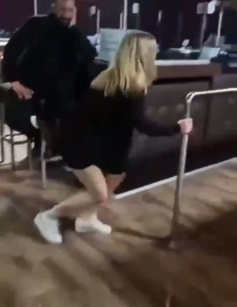 Video Shows a Woman on a Bar Floor as a Voice Repeatedly Warns Oleg