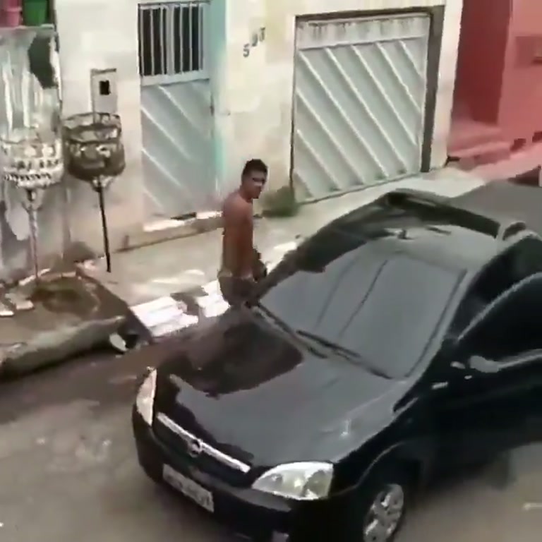 Shirtless Man Kicks a Parked Car, Then Someone Steps Out