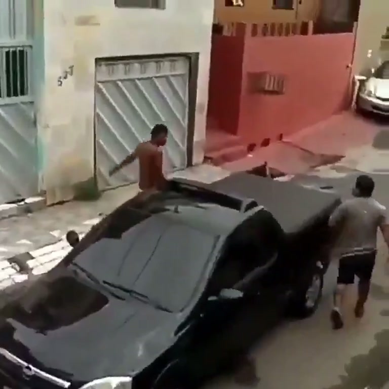Shirtless Man Kicks a Parked Car, Then Someone Steps Out