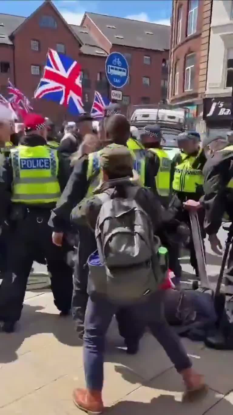 UK Street Clash: Police, a Crowd and a Man on the Ground