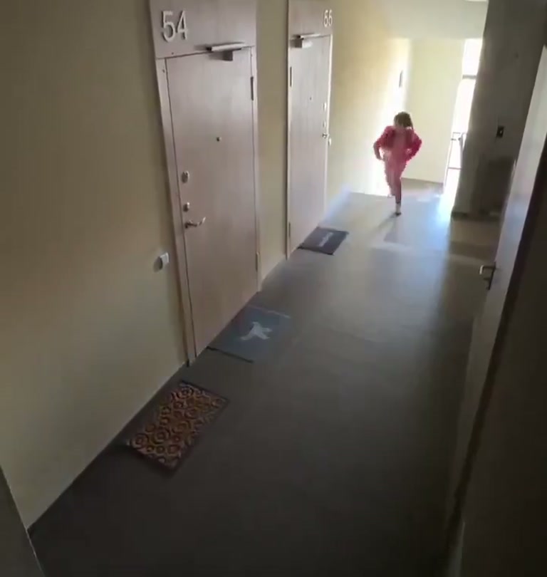 Girl in Pink Keeps Her Cool as Hooded Figure Moves Through Building