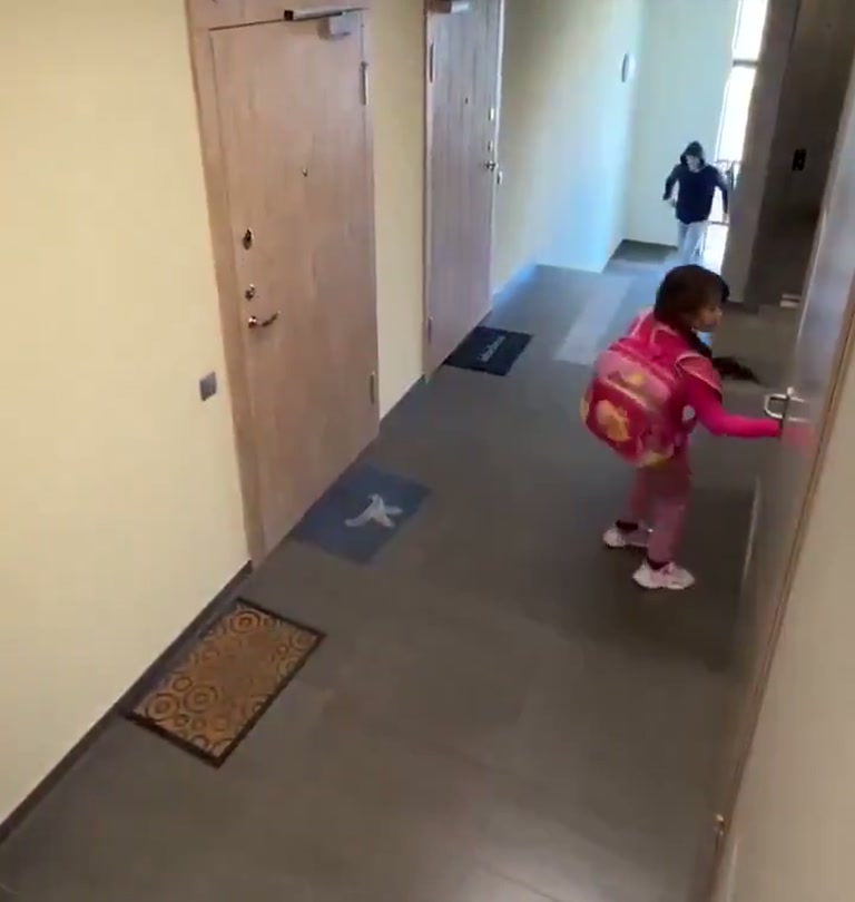 Girl in Pink Keeps Her Cool as Hooded Figure Moves Through Building