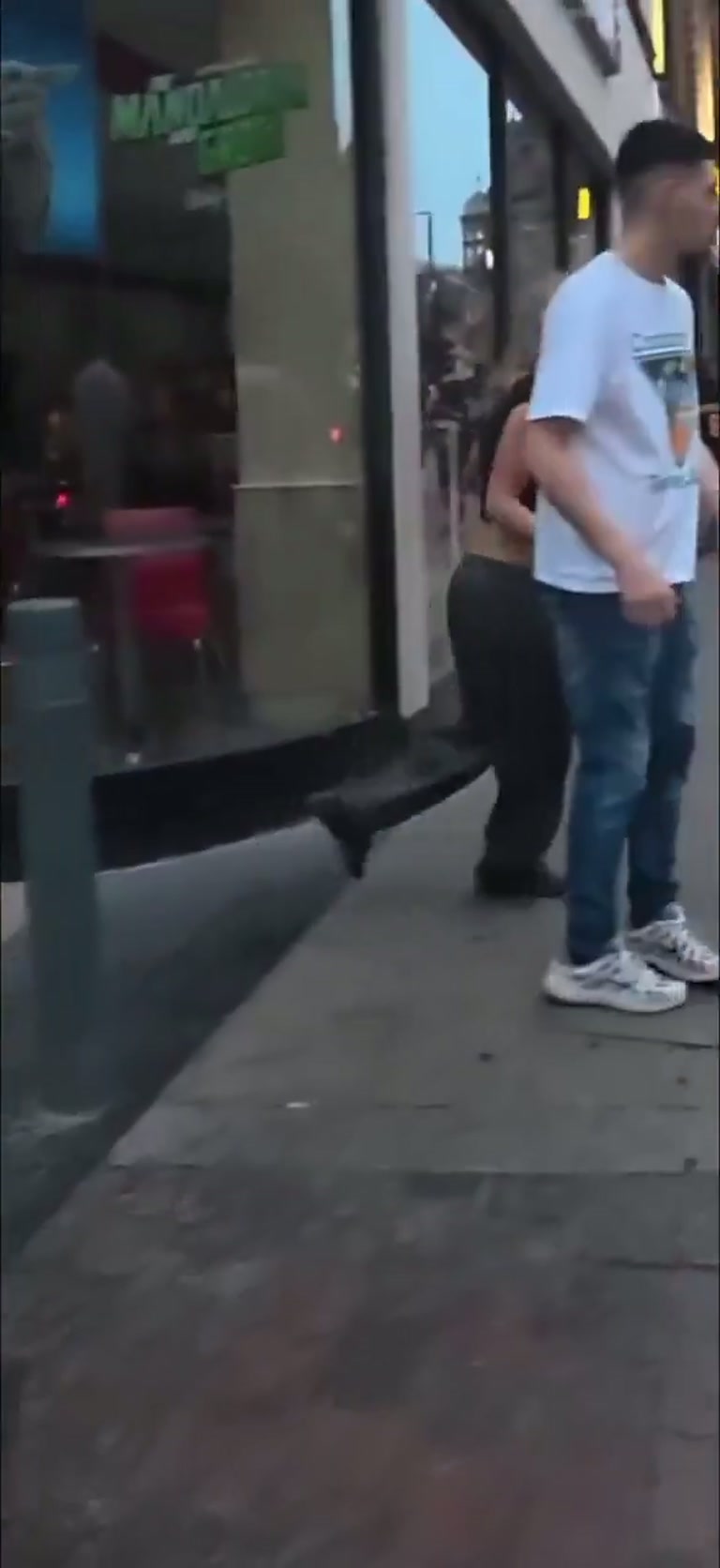A punch from behind on a night street, then the crowd turns