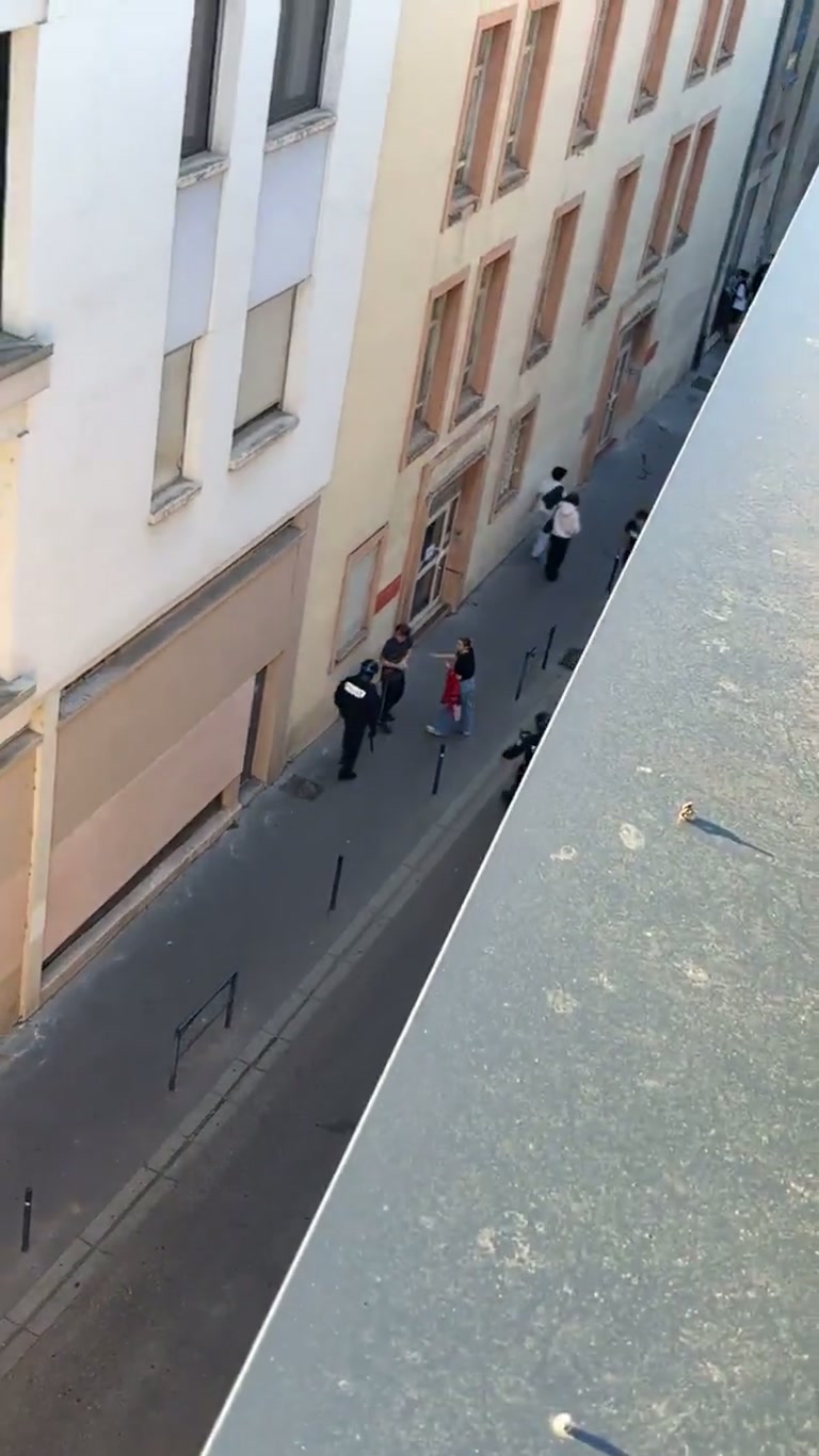 Riot Officers Move In on a Narrow Street Group: Video From a Window