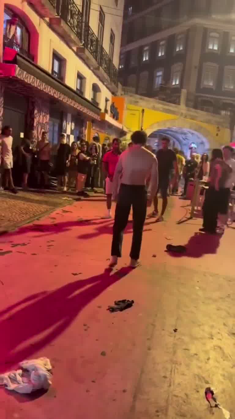 Night Street Scuffle Ends With a Shirtless Walk and a Crowd
