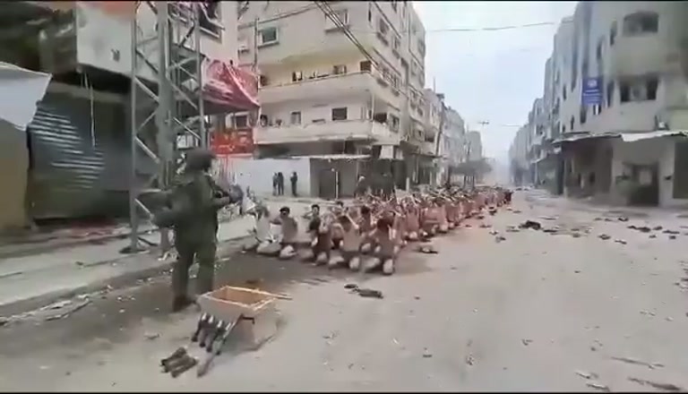Dozens Kneel in a Gaza Street While Armed Men Stand Watch