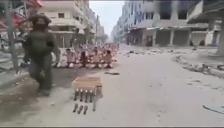 Dozens Kneel in a Gaza Street While Armed Men Stand Watch