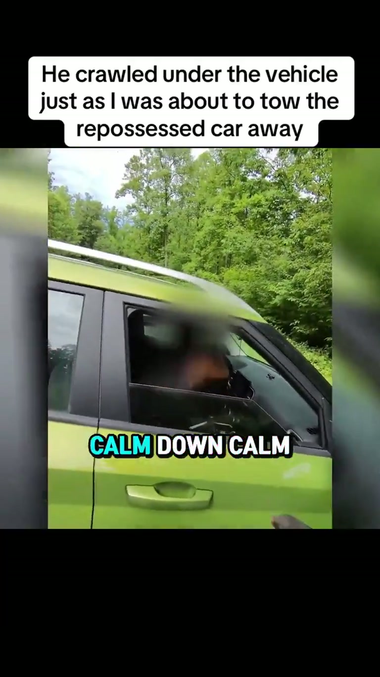Driver Crawls Under Green Car as Repossession Crew Moves In