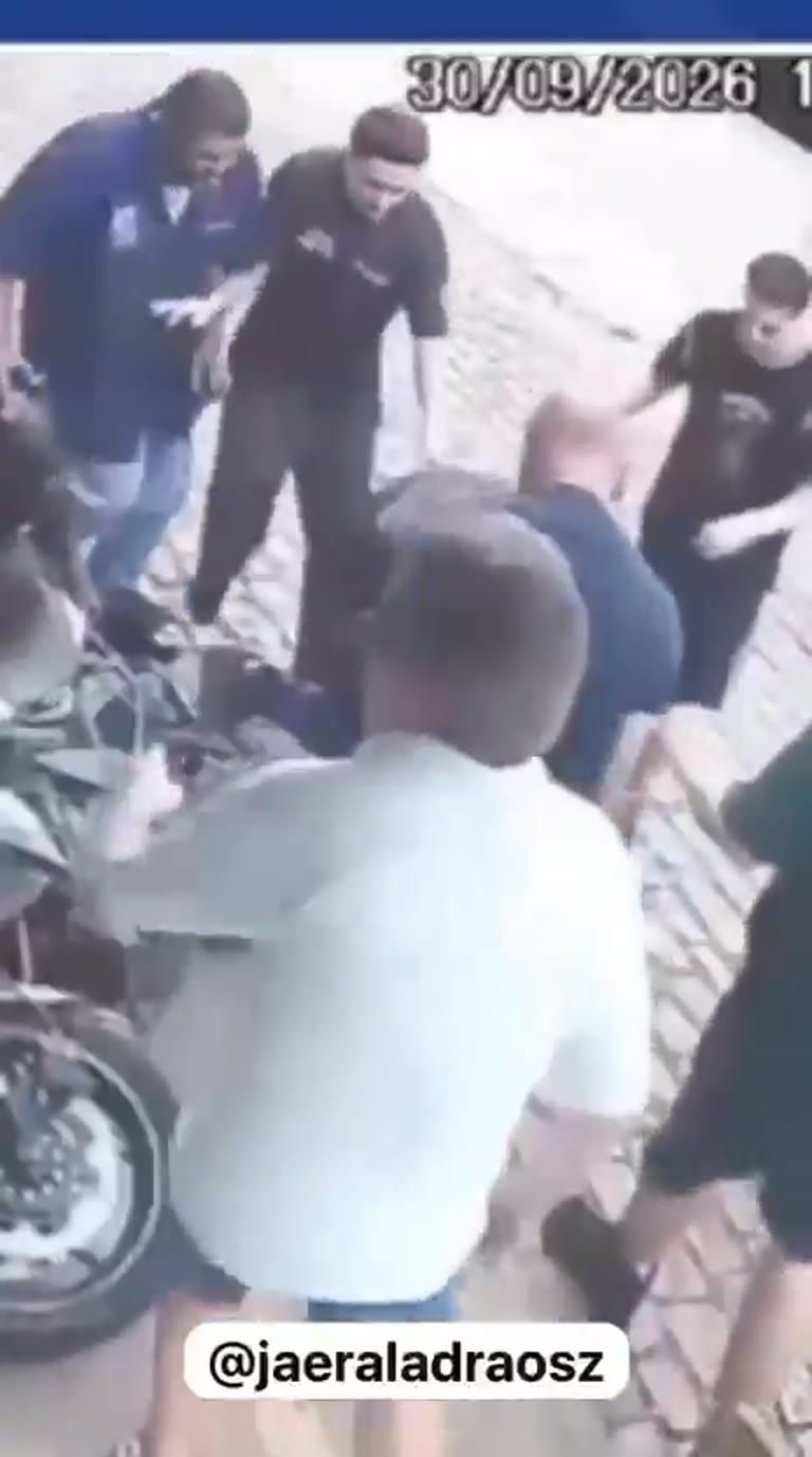Crowd Pins Man on Street as Elderly Woman Arrives With Broom