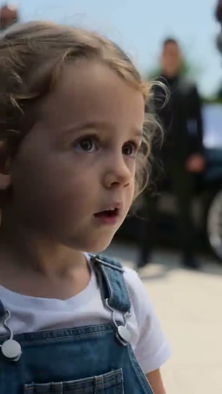 A Child's Pointed Finger Turns a Sunlit Driveway Into a Standoff