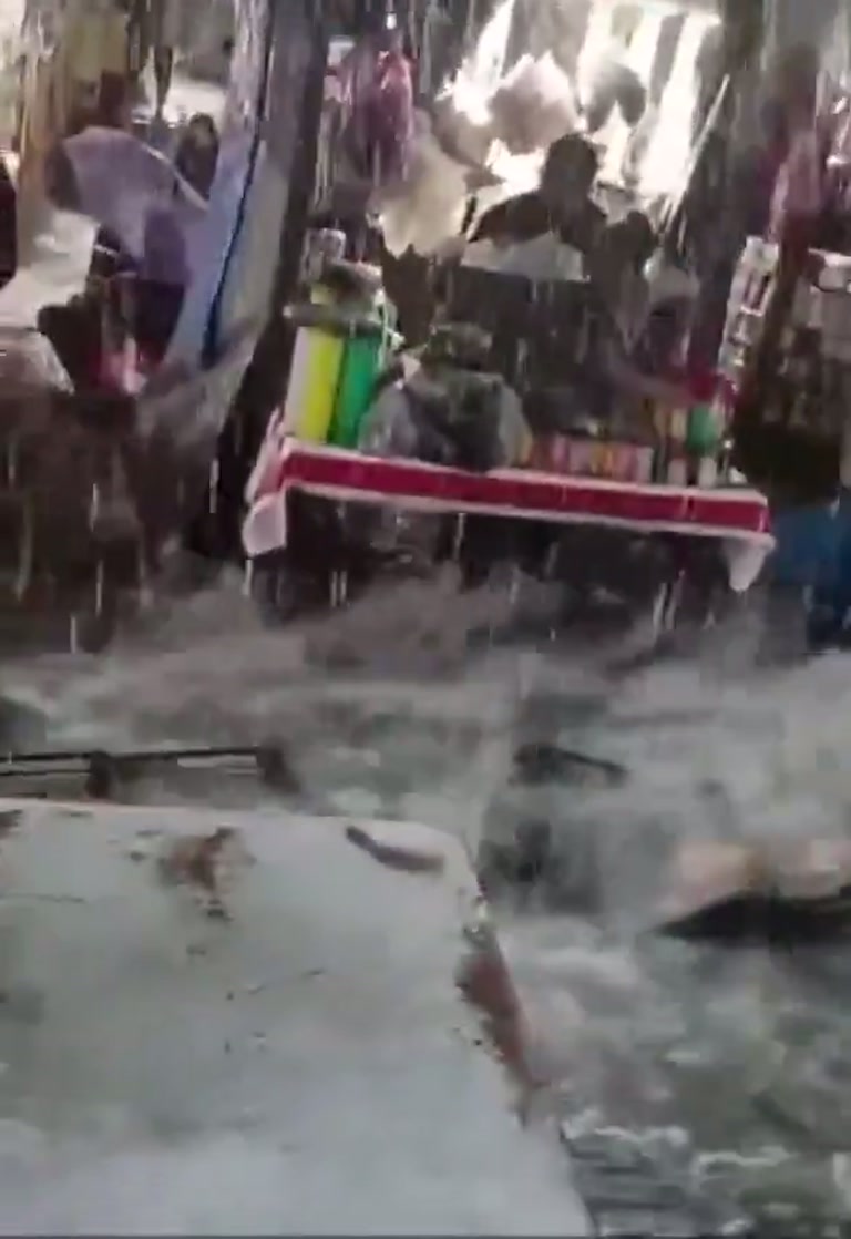Rain Turns a Bustling Market Into a Rushing River in Minutes