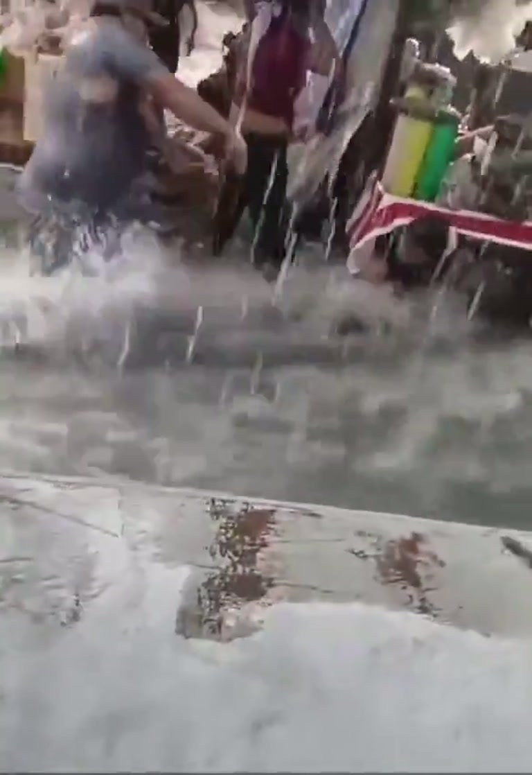 Rain Turns a Bustling Market Into a Rushing River in Minutes