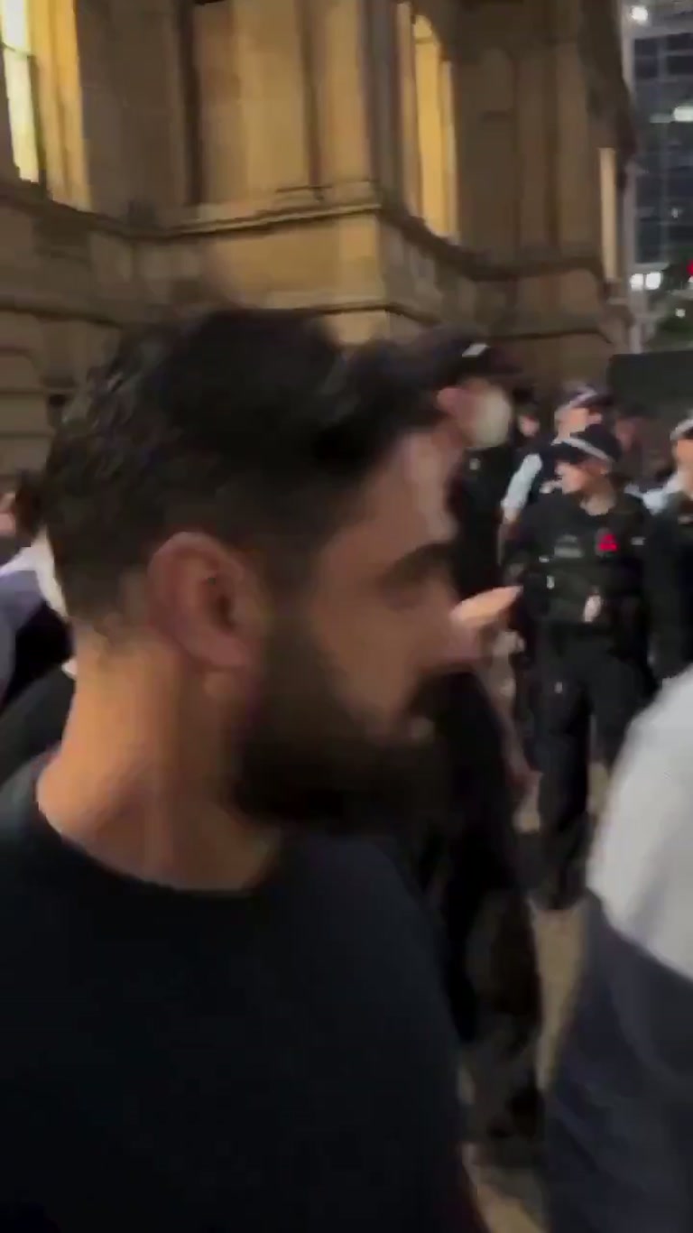 Officers Close In as a Man Kneels in Prayer on a Busy Street