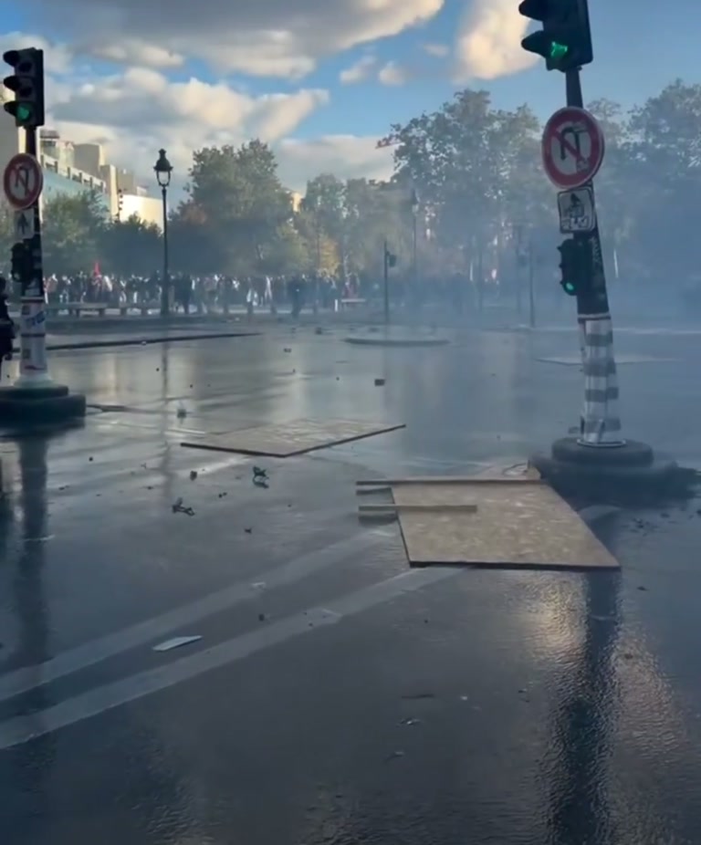Thick Smoke, a Wet Street, and One Figure Who Keeps Walking