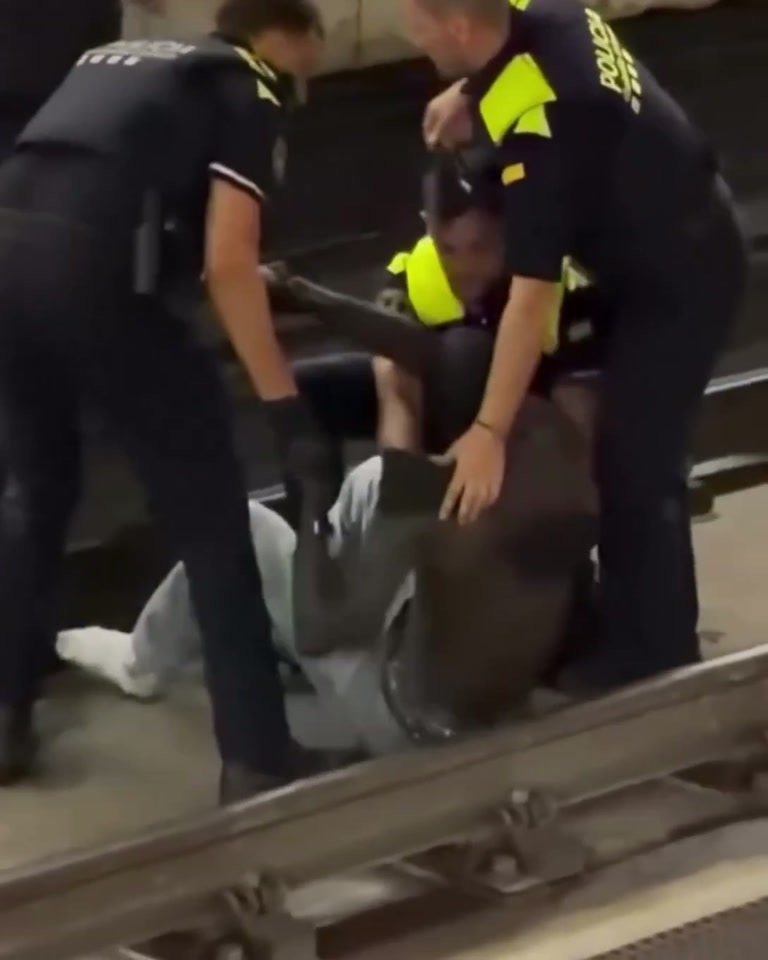 On the Tracks Below a Quiet Platform, Officers and One Calm 'Yes, Sir'