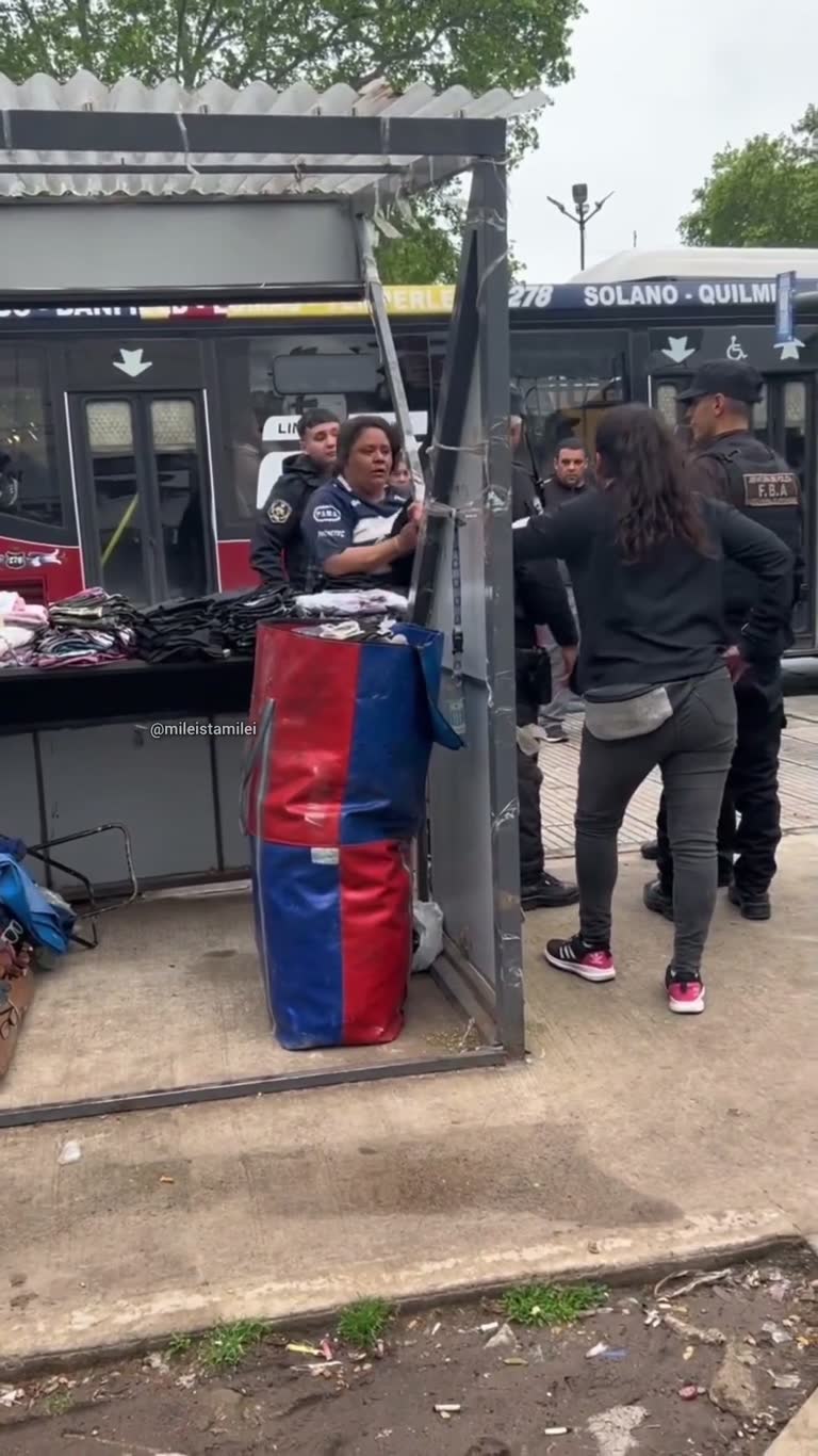 On a Rain-Slick Corner, a Street Vendor's Stall Falls Apart