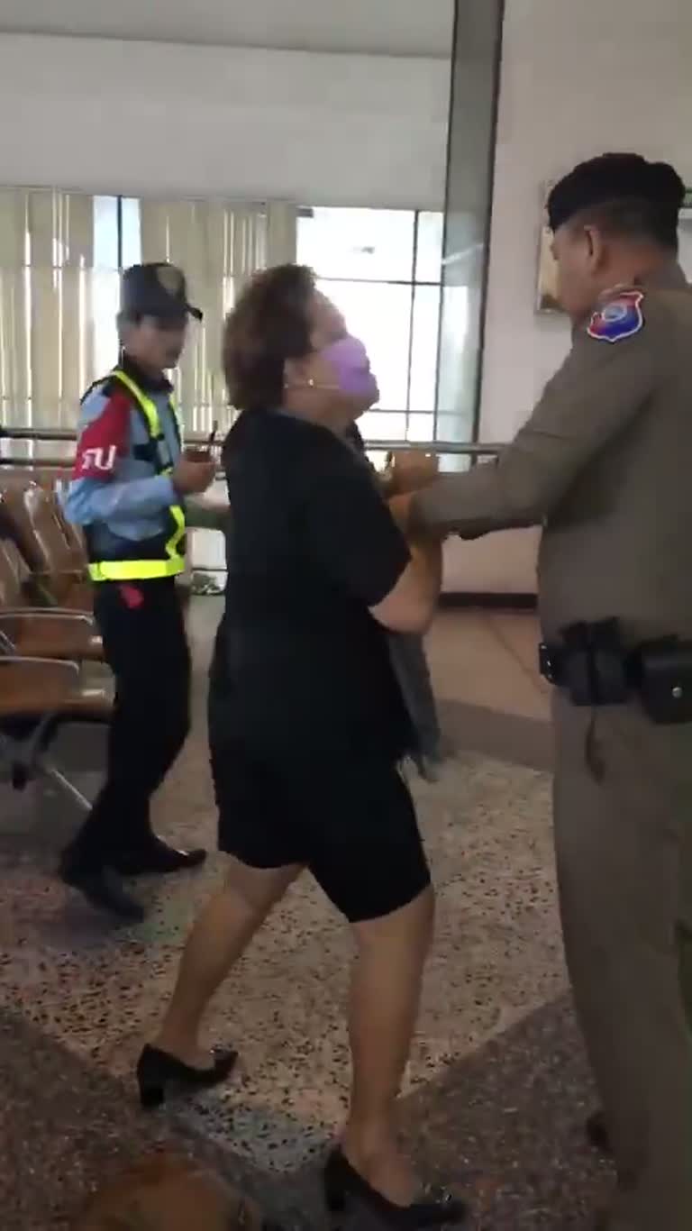 A Purple Mask, a Steady Arm, and an Airport Hall That Goes Still