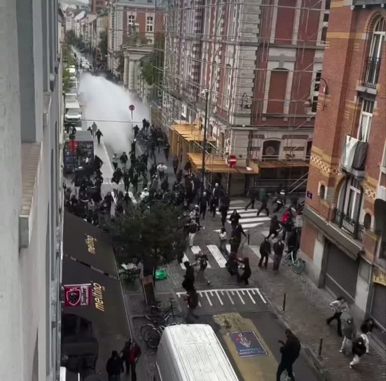 A Quiet Window, a White Jet of Water, and a Street That Turns