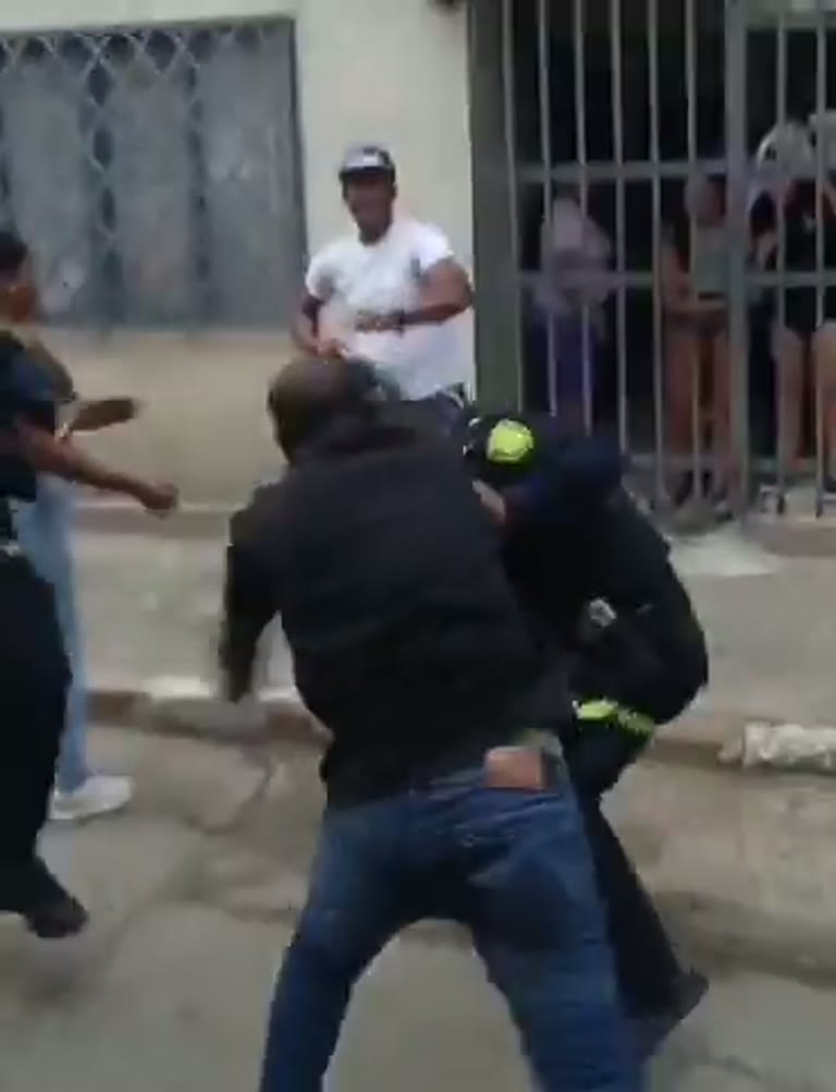 A Man Swings at a Police Officer and a Quiet Street Erupts