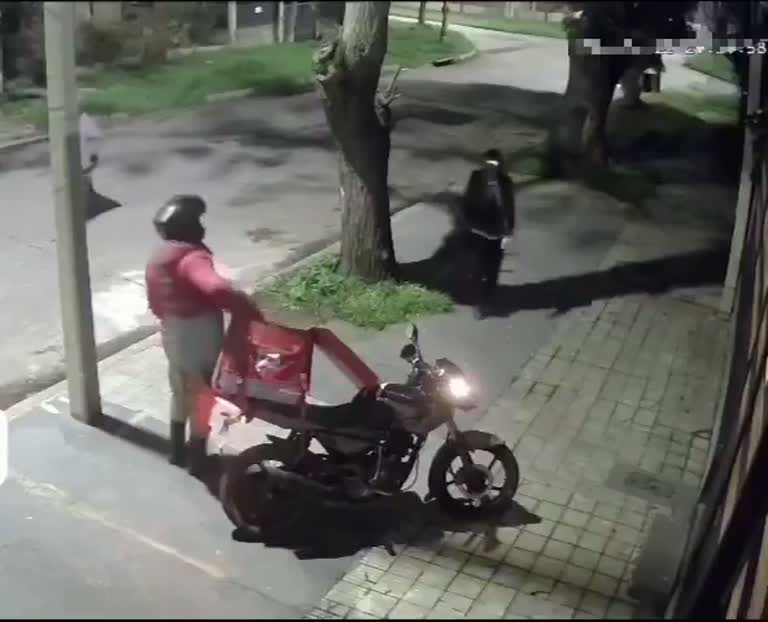 A Delivery Rider Reaches Into His Bag as a Stranger Closes In