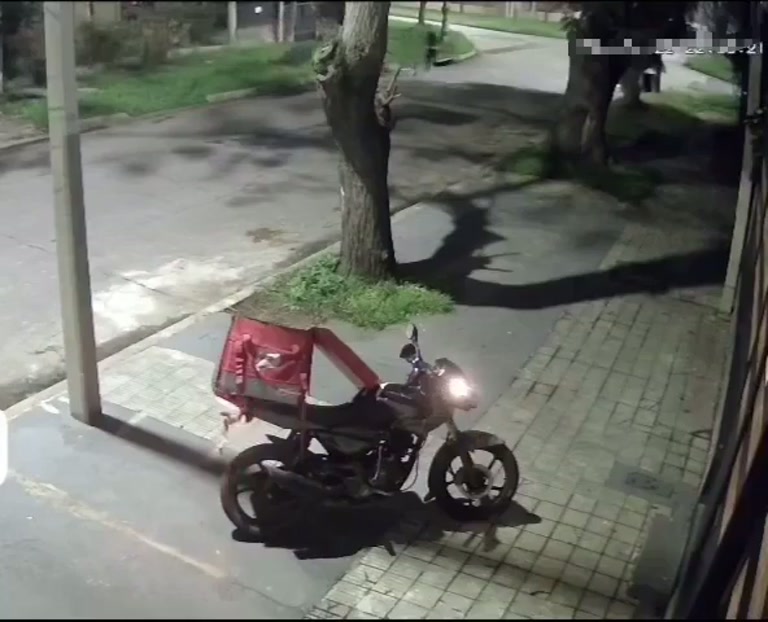 A Delivery Rider Reaches Into His Bag as a Stranger Closes In