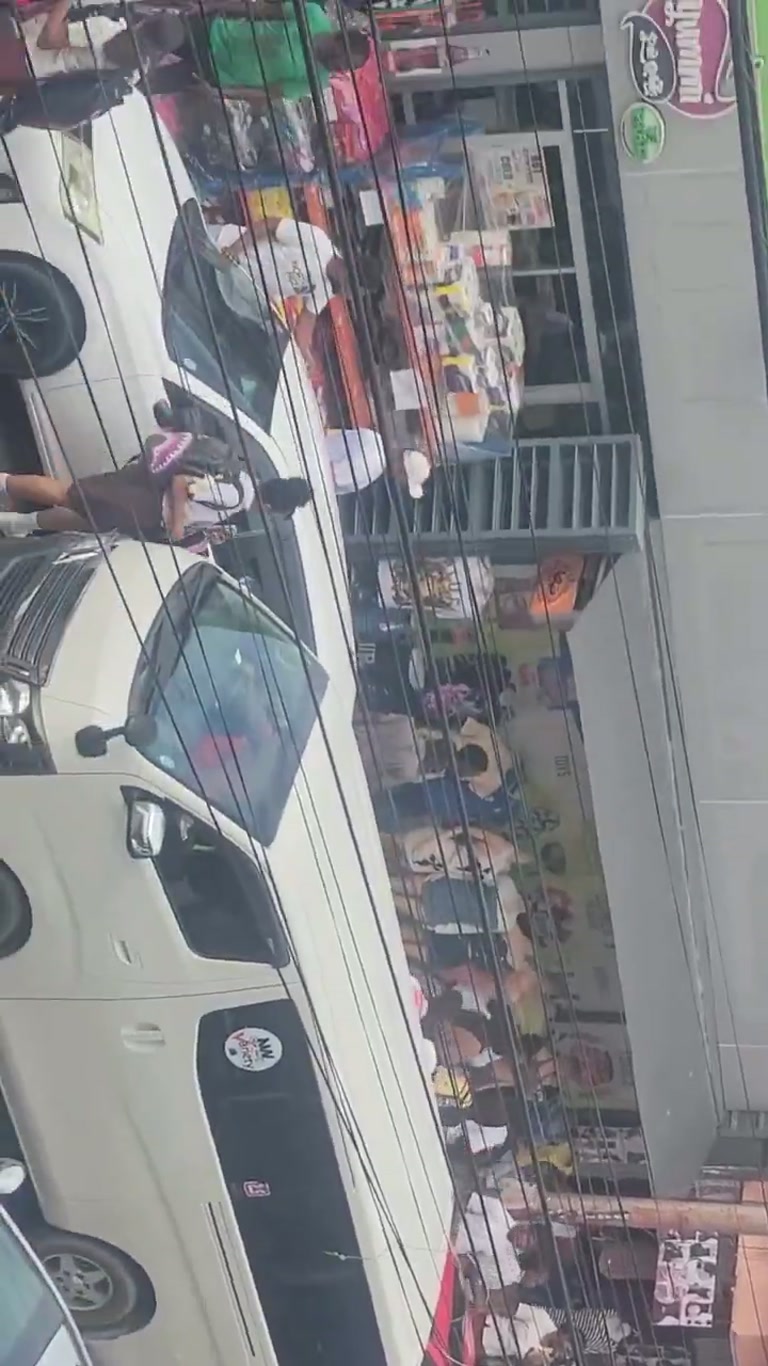 One White Car, a Thousand Bodies, and a Street That Never Stops
