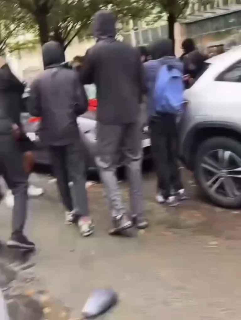 Brussels Crowd Swarms Marked Police Car as Bystanders Film