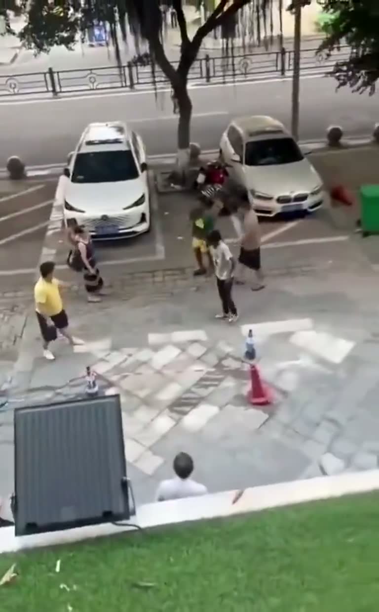 A Sudden Street Scuffle Draws a Crowd of Silent Onlookers