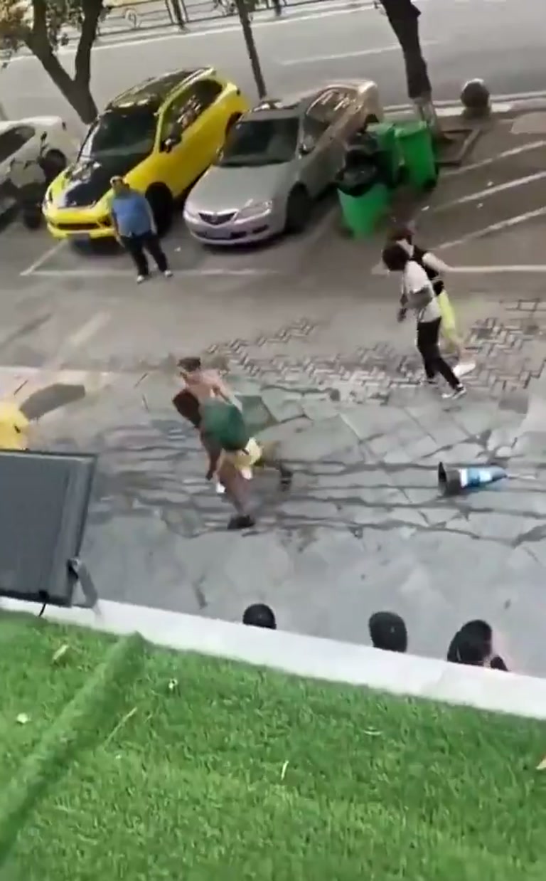 A Sudden Street Scuffle Draws a Crowd of Silent Onlookers