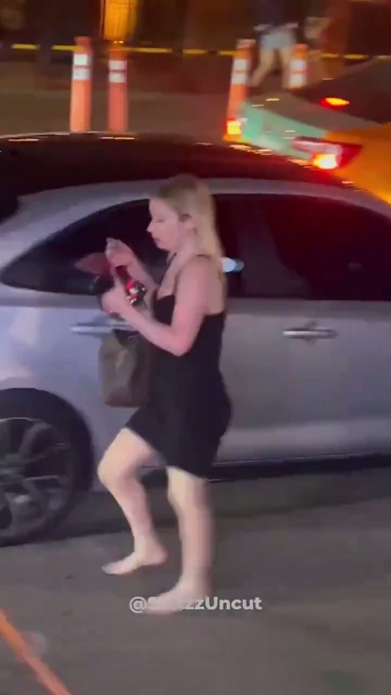 Barefoot Woman Weaves Through Night Traffic as Onlookers Freeze