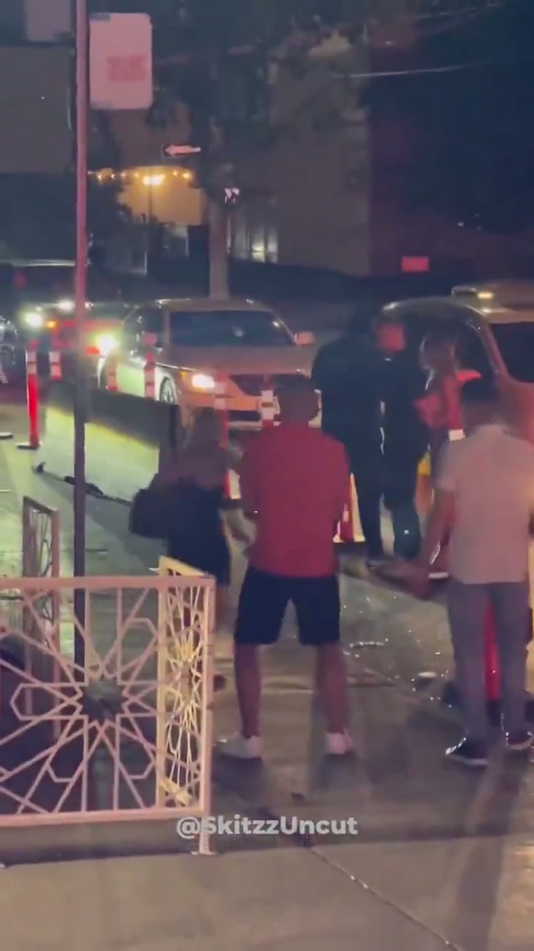 Barefoot Woman Weaves Through Night Traffic as Onlookers Freeze