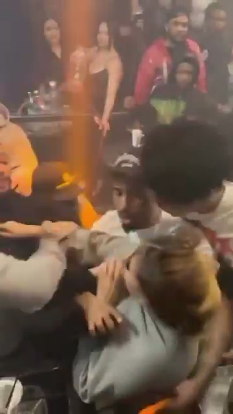 Chaos in a packed bar as a scuffle erupts around a woman