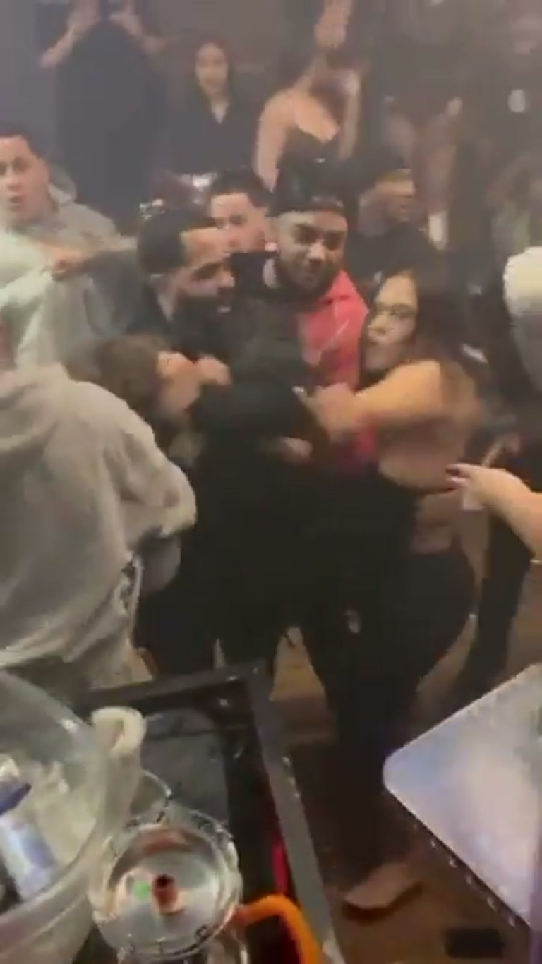Chaos in a packed bar as a scuffle erupts around a woman