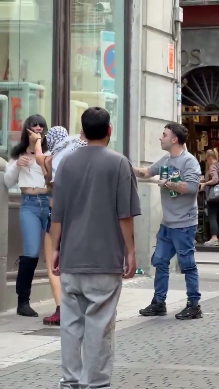 Madrid street scuffle caught on camera as bystanders step in