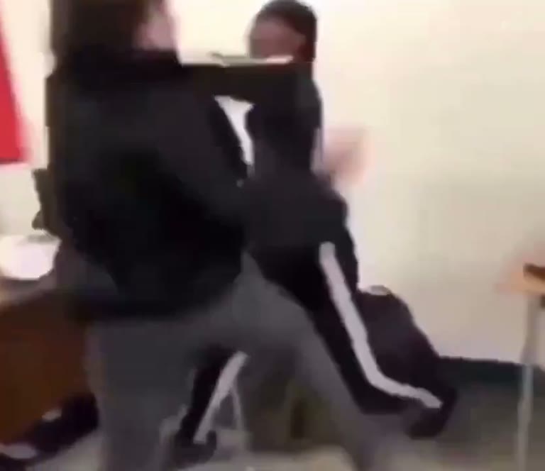 Tense scuffle breaks out in a classroom as a pupil fights back