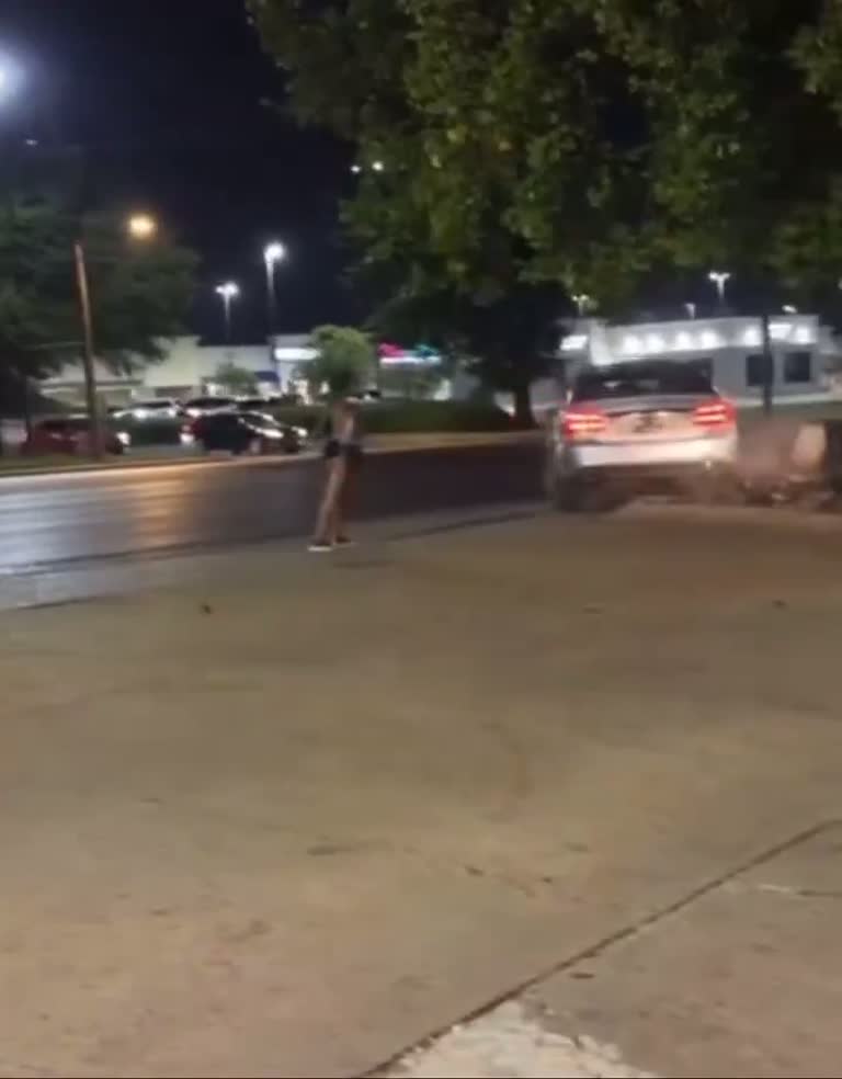 Night-time street standoff after car window shattered