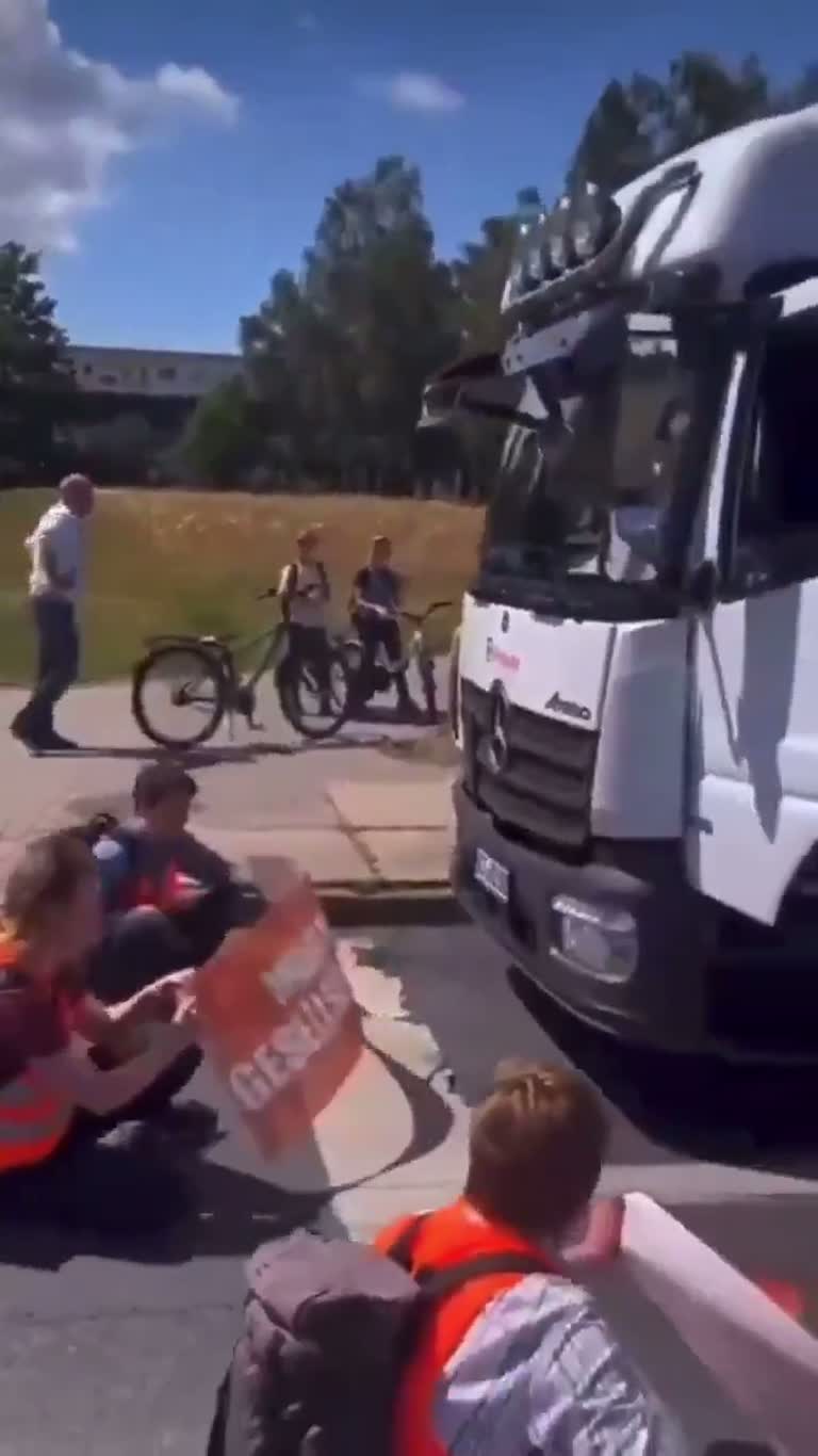 Truck Blocked by Sitting Protesters in Quiet Street Standoff