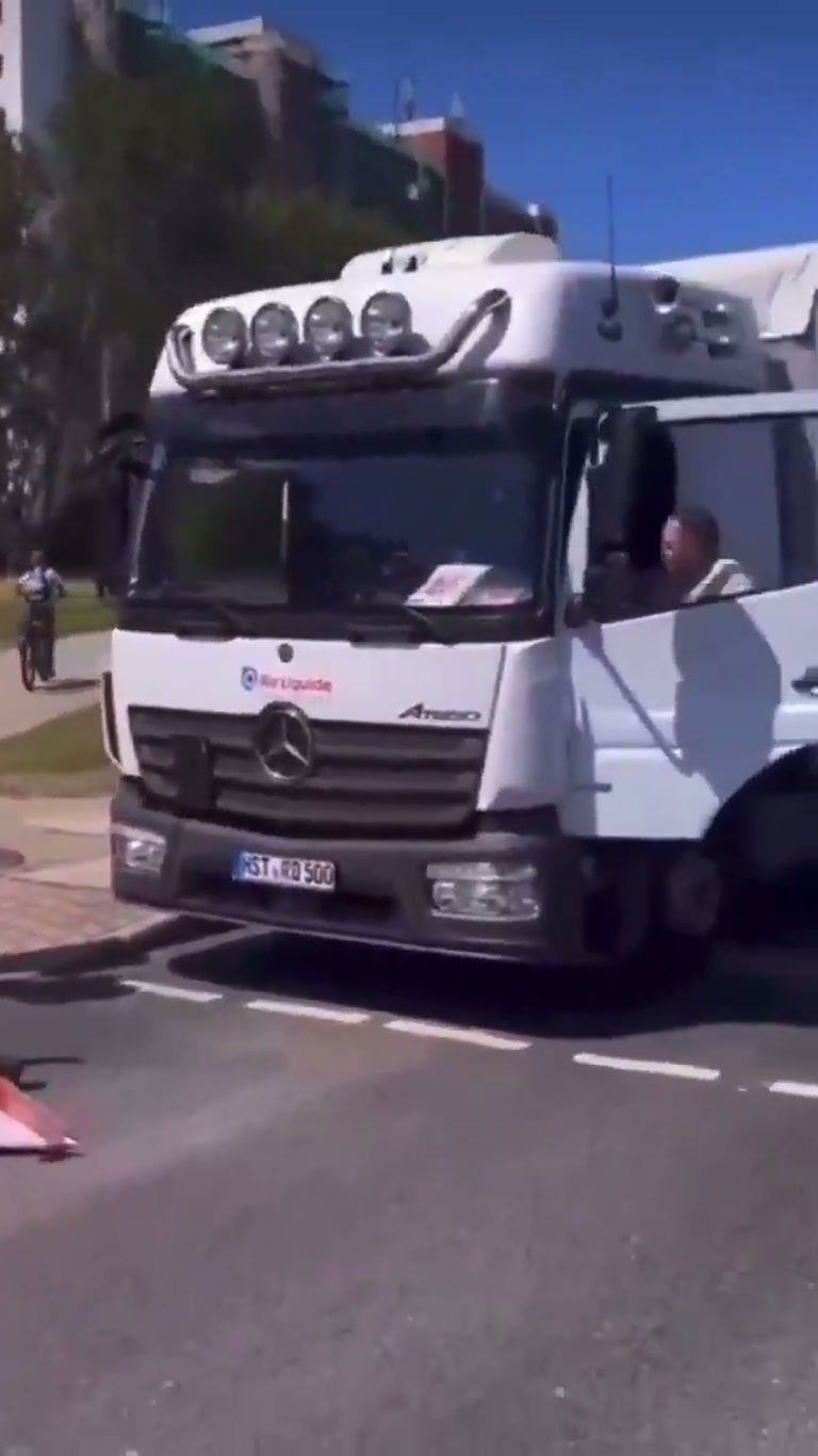 Truck Blocked by Sitting Protesters in Quiet Street Standoff