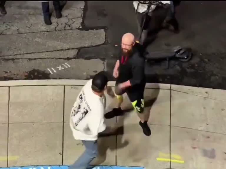 A tense street confrontation leaves one man on the ground